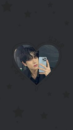 a person taking a selfie in front of a heart with stars on the background