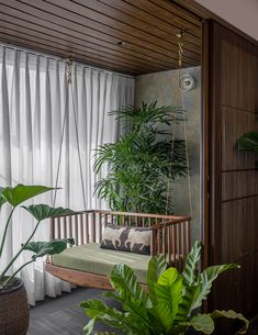 a living room filled with lots of green plants