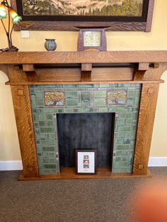 a fireplace in a room with a painting on the wall