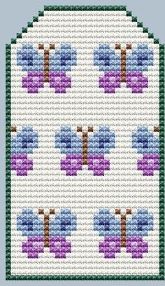 a cross stitch pattern with blue and purple flowers on the side, in front of a white background