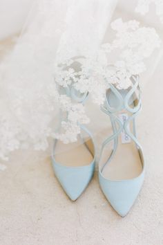 the bride's blue shoes are adorned with white flowers