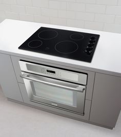 a stove top oven sitting inside of a kitchen next to a wall mounted oven door