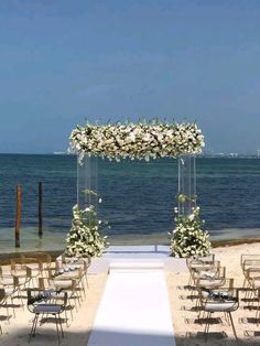 an outdoor ceremony set up on the beach