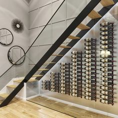 there is a wine rack on the wall next to the stairs in this modern home