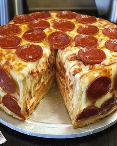 a pepperoni pizza is cut into two pieces on a platter with one slice missing