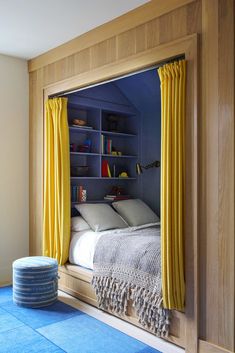 a bedroom with blue carpet and yellow curtains on the window sill in front of it