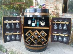 a wine barrel with several bottles and glasses on it