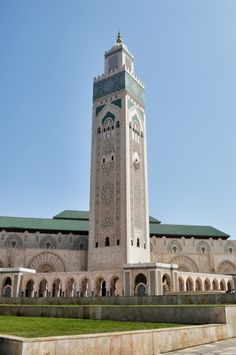 a tall tower with a clock on it's side in front of a building