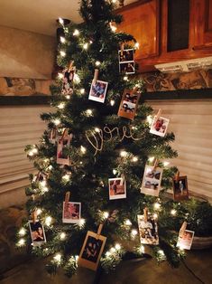 a christmas tree with pictures and lights on it