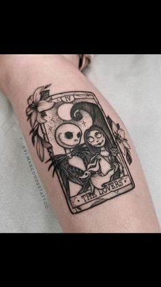 a person with a tattoo on their arm that has a playing card in front of them