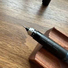 a pen sitting on top of a wooden desk