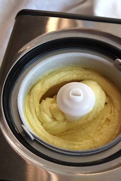 a blender filled with yellow liquid on top of a table