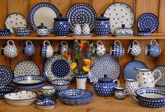 blue and white dishes are on display with flowers