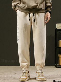 Russoo - Mens Classic Tapered Jogger Pants: Casual Sportswear with Timeless Design Spring Letter Print Joggers For Jogging, Casual Beige Sports Pants, Casual Stretch Pants With Letter Print, Casual Beige Pants For Sports, Beige Casual Sports Pants, Sportswear Pants With Letter Print For Spring, Sportswear Style Letter Print Pants For Spring, Sportswear Letter Print Pants For Spring, Casual White Pants For Gym