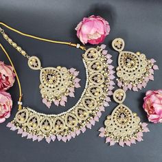 Elevate your elegance with our exquisite Baby Pink Indian Asian Bollywood Jewelry Set. This captivating bridal choker fashion necklace, paired with stunning earrings and a delicate tikka, exudes timeless charm fit for a wedding or any special occasion. Crafted with precision, this set showcases intricate detailing and the delicate hue of baby pink, adding a touch of ethereal beauty to your ensemble. Designed to complement the grace of women, this jewelry set is more than adornment; it's an expre Pink Wedding Necklaces With Matching Earrings, Pink Necklaces With Matching Earrings For Wedding, Pink Bridal Necklace With Matching Earrings For Wedding, Elegant Pink Bridal Sets For Party, Elegant Kundan Dangle Necklace For Wedding, Hand Set Jewelry Sets For Wedding, Pink Dangle Necklaces For Wedding, Pink Elegant Jewelry For Wedding, Elegant Pink Jewelry For Wedding