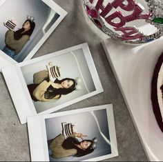 four polaroid photos sitting on top of a table next to a plate with cake