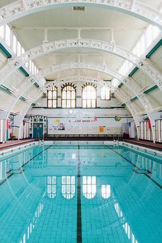 an indoor swimming pool with clear blue water