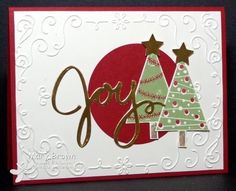 a handmade christmas card with two trees and the word joy in gold on it