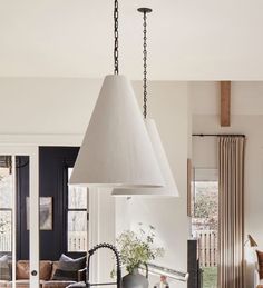 a kitchen with an island, sink and hanging lamp in the middle of the room