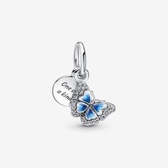 Take a moment to reconnect with nature this spring and enjoy the beauty of the season with our Blue Butterfly & Quote Double Dangle Charm. Featuring hand-painted wings and brilliant-cut clear cubic zirconia, this charm also has a sterling silver medallion engraved with the message "One of a kind." Just like butterflies in nature, each charm is completely unique. Wear it with our matching blue butterfly earrings for a coordinated statement this spring. Pandora Butterfly, Butterfly Quote, Pandora Blue, Butterfly Quotes, Charms Pandora, Bracelet Pandora, Butterfly Bracelet, Pandora Bracelet Charms, Pandora Bracelets