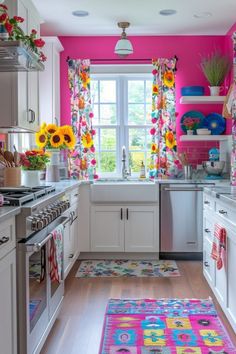 a kitchen with sunflowers on the window sill and rug in the floor