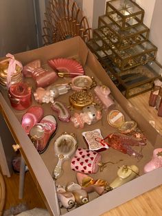 a box filled with assorted items on top of a wooden floor