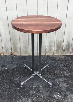 a round wooden table sitting on top of a sidewalk