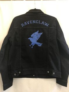 a black jacket with blue raven claw on it