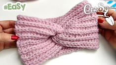 a close up of a person holding a knitted bow