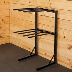 a wooden wall with two black metal racks on it