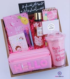 a pink gift box filled with personal care items and writing on the side, along with a notepad