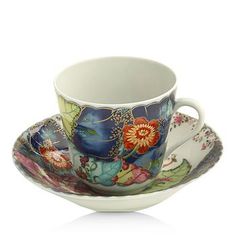 a cup and saucer decorated with flowers