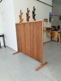 a wooden divider sitting on top of a tile floor