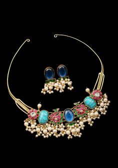 hasli or the rigid piece of necklace with an open back worn by the tribal women of the north has become an iconic piece of jewelry! This hasli and earrings set comes with Blue and Pink stones and dense clusters of beads hang below. With its lively elements, it is sure to add an extra touch of glitz and grandeur. ote: This jewelry has no precious metals or stones.  Note: Some of the pics are close up shots to show detail and may make the product appear larger. Please refer to the measurements picture for better perspective on size. Antique Necklaces Design, Pink Stones, Antique Necklace, Pink Stone, Antique Finish, Blue And Pink, Salwar Kameez, Earrings Set, Necklace Designs