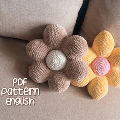 a crocheted flower sitting on top of a couch next to a pillow with the words pattern english written below it