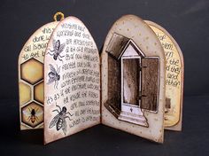 an open book with some drawings on it and a beehive in the middle