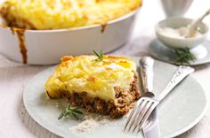 a piece of meat and cheese pie on a plate with a fork next to it