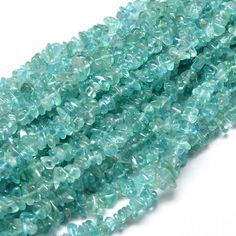 aqua green faceted glass beads with small holes in the middle, on white background