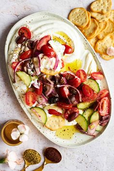 a white plate topped with vegetables and crackers