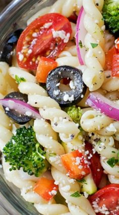 a pasta salad with tomatoes, broccoli and onions