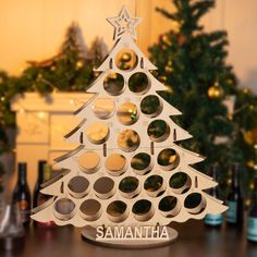 a christmas tree made out of wine bottle caps with the name samantha on it