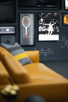 a living room filled with furniture and pictures on the wall