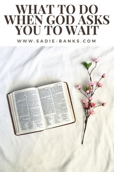 an open book with pink flowers next to it and the words when god asks you to wait