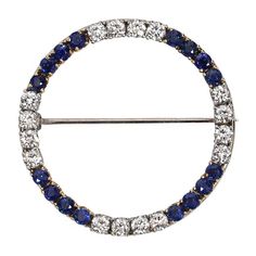 This is part of Chairish’s Fine Jewelry assortment.  Introducing our exquisite Vintage Diamond and Sapphire Circle Brooch, a true testament to timeless elegance and luxurious craftsmanship. This magnificent piece showcases a harmonious blend of 14 karat white and yellow gold, accentuated by dazzling diamonds and a captivating sapphire. At the heart of this brooch, a brilliant 1.25 carat diamond takes center stage, radiating brilliance and sophistication. Its mesmerizing facets reflect light from Classic Round Diamond Brooches, Classic Diamond Brilliant Cut Brooch, Classic Diamond Brooch With Brilliant Cut, Classic White Gold Brooch With Brilliant Cut, Classic White Gold Brooches With Single Cut Diamonds, Classic Diamond Brooches With Brilliant Cut, Classic Diamond Brooch, Luxury Brilliant Cut Brooches For Anniversary, Round Single Cut Diamond Brooches