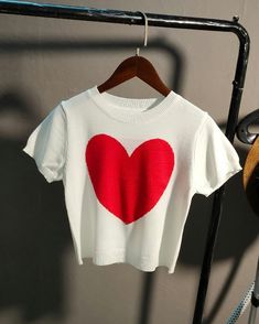 Cute and girly Great paired with jeans Perfect for casual mall dates Cute Tops With Heart Graphic For Spring, White Knit T-shirt With Short Sleeves, White Knit T-shirt For Summer, Trendy Heart-shaped T-shirt For Spring, Cute White Knit Top, Trendy Crew Neck Top With Heart Graphic, Trendy Red Top With Heart Print, Cute Red Heart-shaped Top, Cute Knit Tops With Heart Print