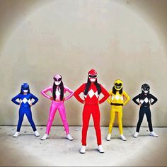 five different colored power rangers are standing in a row with their hands on their hipss