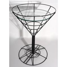 a glass table with metal stand and circular base on the top, against a white background