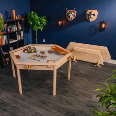 a wooden table sitting in front of a blue wall