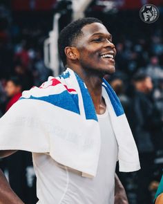 a close up of a person wearing a towel and holding a basketball in his hand