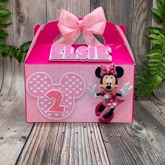 a pink minnie mouse box with a bow on it's head and the number two